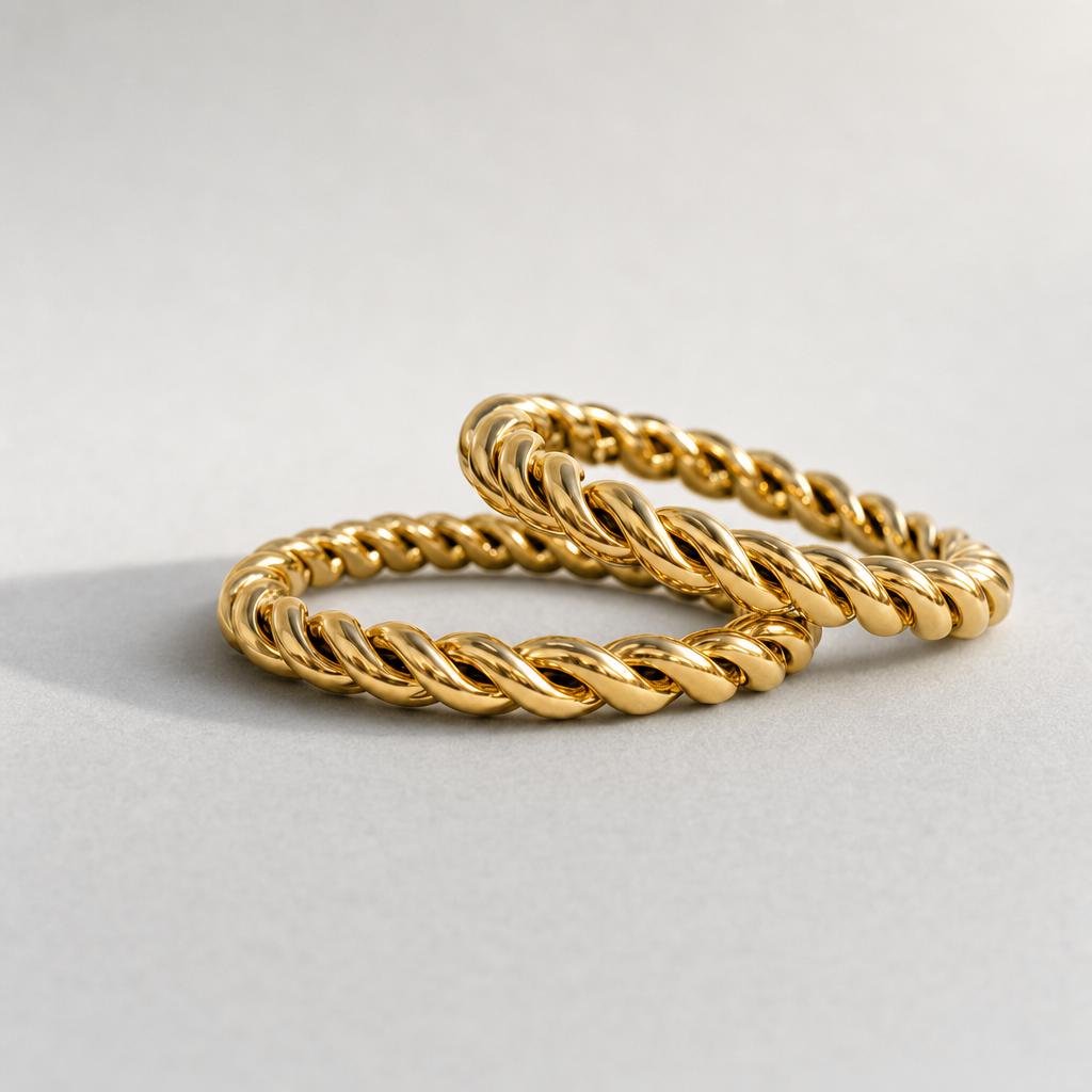 Two Alta Studio Twisted Band rings in 18k gold