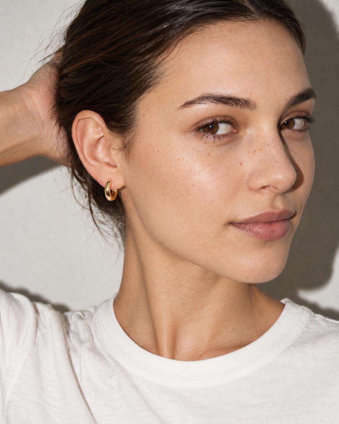 Woman wearing a gold hoop earring