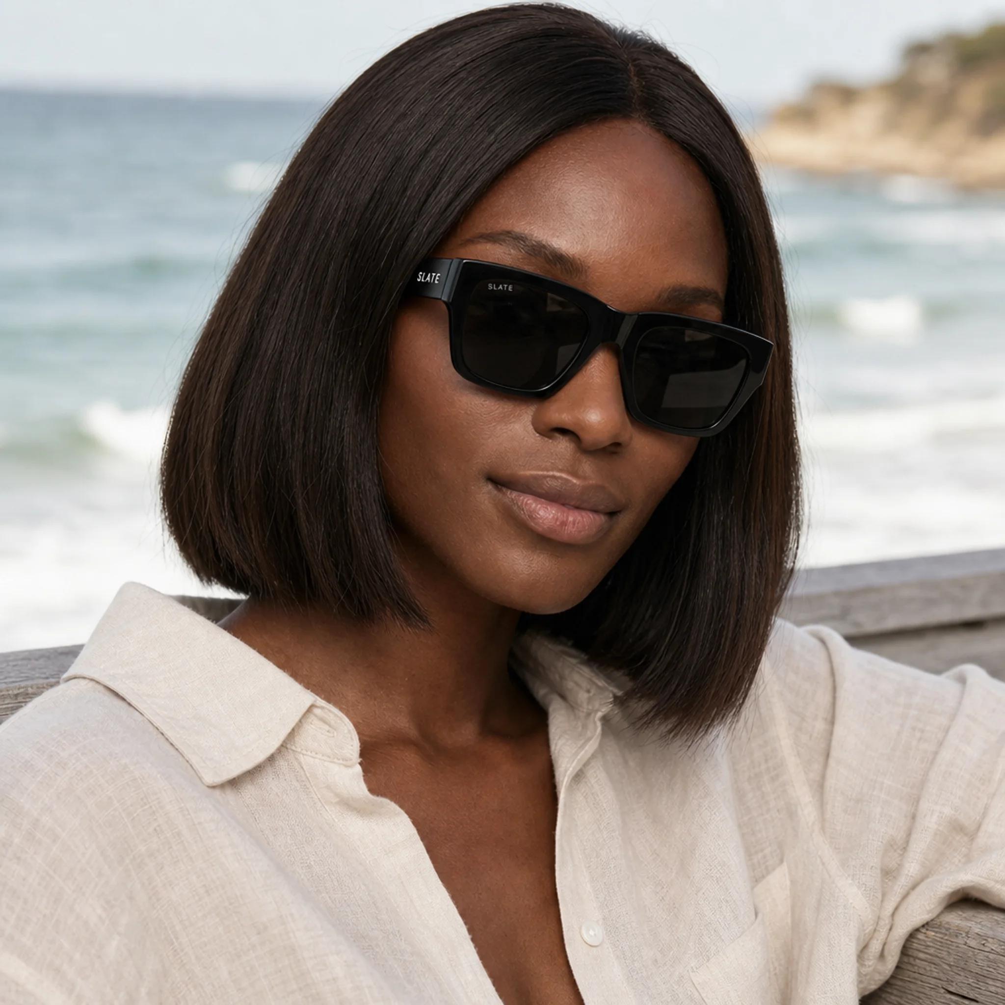 Woman wearing Slate Mesa sunglasses by the coast